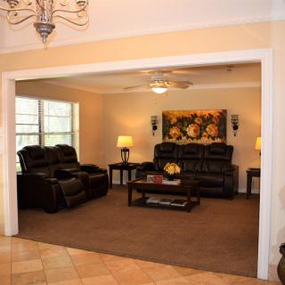 A cozy living room with comfortable leather seating and warm lighting.
