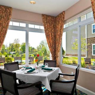 A beautifully arranged dining area with a scenic window view.