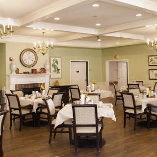 A well-decorated dining room featuring elegant tables and chairs, set in a cozy atmosphere.