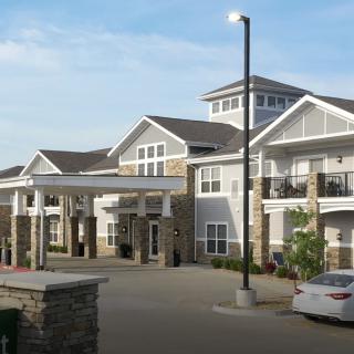 A modern residential building with a spacious driveway and contemporary design.
