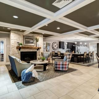 A stylish and modern open-space living room featuring a cozy fireplace, comfortable seating, and elegant interior design.