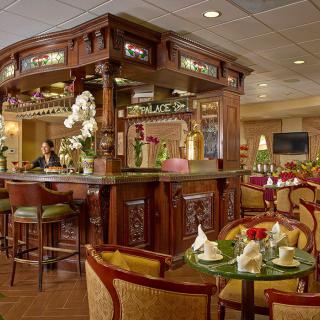 A traditional bar and restaurant interior with wooden furnishings and floral decorations.