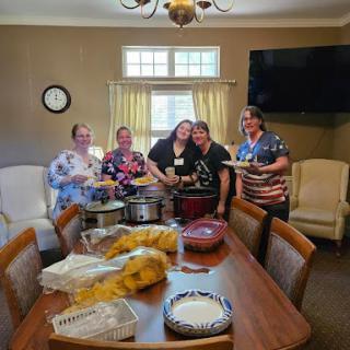 A joyful gathering of friends cooking and sharing delicious food together.
