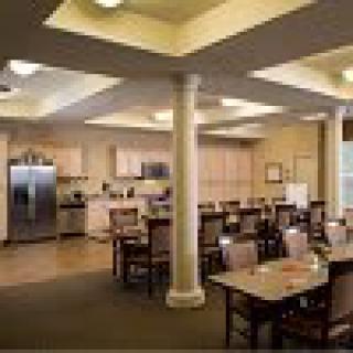 A modern kitchen and dining area with ample seating and contemporary lighting.