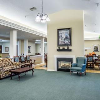 A cozy community living room with comfortable seating and a fireplace.