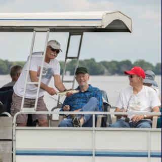 A group of friends enjoying a day out on the boat.