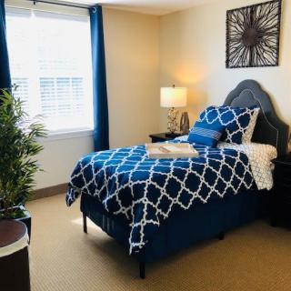 A modern bedroom with blue geometric bedding and stylish decor.