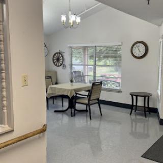 A bright and modern dining area featuring a table, chairs, and large windows that allow for ample natural light.