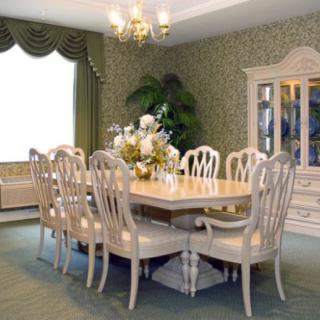 A traditional dining room with elegant furniture and a chandelier.