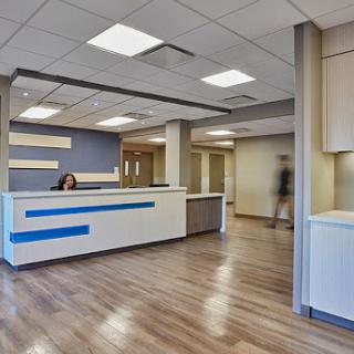 A modern reception area featuring a clean design and functional workspace.