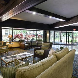 A modern, spacious lobby area with comfortable seating and large windows allowing natural light.