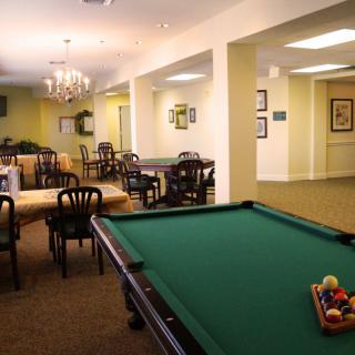 A recreation room featuring a pool table and seating area.