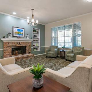 Cozy living room with a fireplace, comfortable seating, and elegant decor.