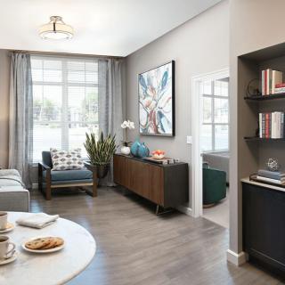 A modern living room with stylish furniture and large windows providing ample natural light.