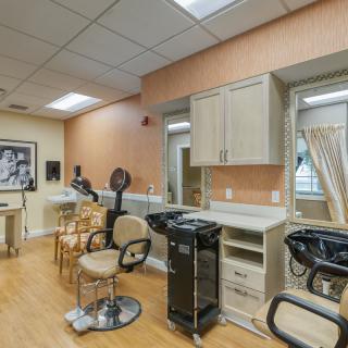 A well-equipped salon interior featuring hairdressing chairs and styling stations.