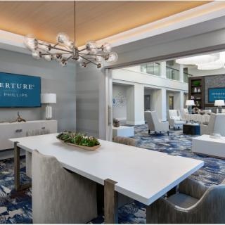 A modern conference room with sleek furniture and a stylish chandelier.