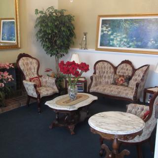 A cozy living room with vintage furniture and decorative elements.