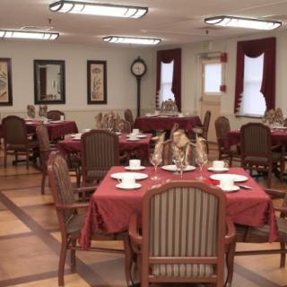 An elegant dining room with neatly arranged tables and chairs, ready for guests.