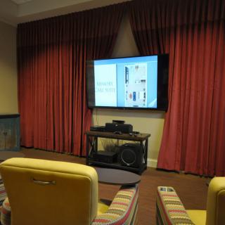A cozy home theater setup with a television and comfortable seating.