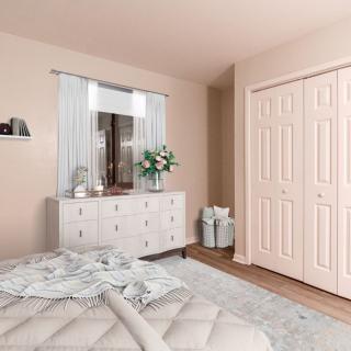 A cozy bedroom featuring a dresser with a mirror, pastel walls, and decorative accents.