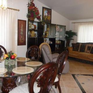 A cozy living and dining area featuring elegant furniture and decorative elements.