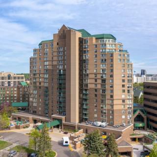 A tall residential apartment building in an urban setting.