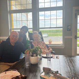 A warm family gathering with smiles shared over a table.