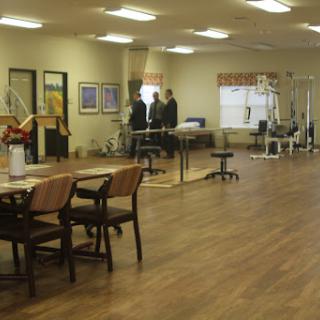 A spacious rehabilitation center equipped with exercise areas and a warm, professional ambiance.