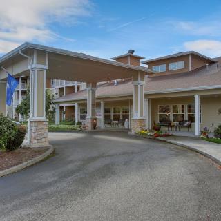 A welcoming entrance to a residential building with landscaped surroundings.