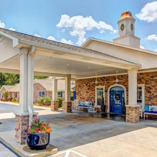 A welcoming entrance to a beautifully designed building featuring landscaped outdoor areas.