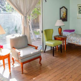 A cozy living room with elegant furniture and ample daylight.