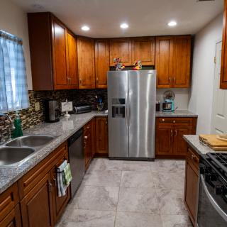 A modern kitchen with wooden cabinets and stainless steel appliances.