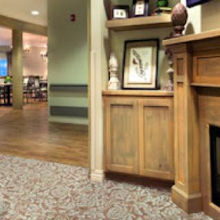 A cozy interior scene featuring a wooden cabinet and decorative elements, inviting a warm atmosphere.