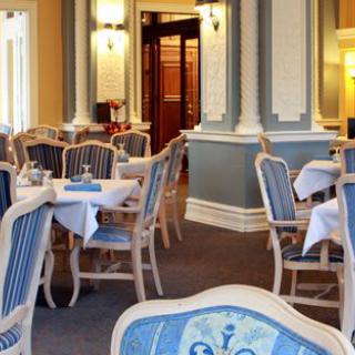 An elegant dining room with beautifully set tables and classic furniture.