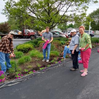 A group of people gardening together in a community space.