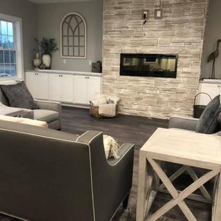 A modern living room with a cozy fireplace and stylish furniture.