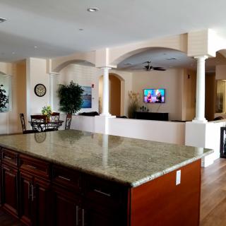 Spacious open floor plan featuring a kitchen island and cozy living area.