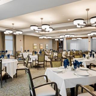 An elegantly designed dining area with neatly arranged tables and stylish lighting.