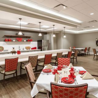 A well-decorated dining area with red-themed decor and modern lighting.