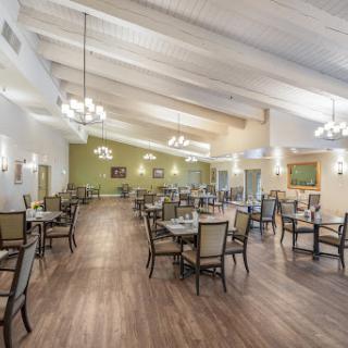 A spacious dining area featuring elegant decor and ample seating arrangements.