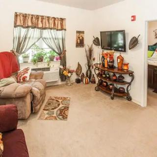 A cozy living room with comfortable seating, a TV, and decorative elements.