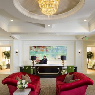 Luxurious hotel lobby with elegant chandelier and comfortable seating.