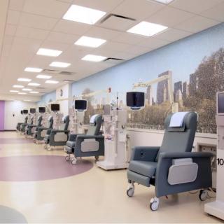 A row of medical treatment chairs and equipment in a healthcare facility.