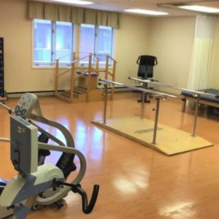 A physical therapy room equipped with exercise and rehabilitation tools.