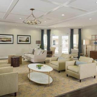 A modern living room with elegant furniture and bright lighting.