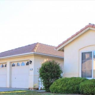 A suburban house with a two-car garage and well-maintained landscaping.