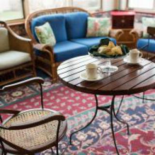 A cozy living room with a wooden table and comfortable seating.