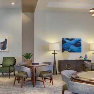 A modern living room with stylish furniture, artwork, and ambient lighting.