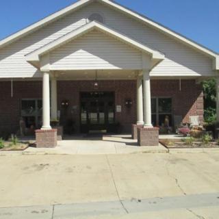 Front view of a building with columns and a porch.