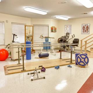 A physical therapy room equipped with various rehabilitation and exercise tools.
